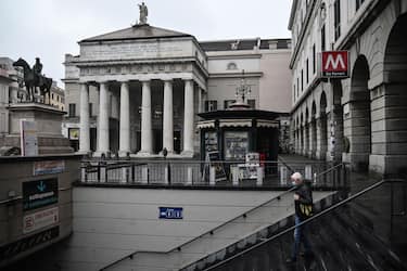 A man enters a subway station by the Carlo Felice theater (Rear) in Genoa, Liguria, on March 13, 2020 as Italy shut all stores except for pharmacies and food shops in a desperate bid to halt the spread of a coronavirus. (Photo by Marco BERTORELLO / AFP) (Photo by MARCO BERTORELLO/AFP via Getty Images)