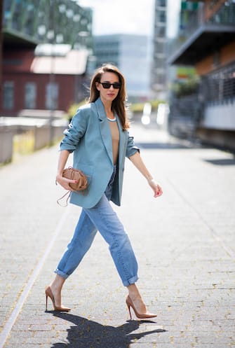 DUSSELDORF, GERMANY - JUNE 09: Alexandra Lapp is seen wearing Victoria Beckham tanktop in beige, GRLFRND high waist Jeans Devon, double breasted blazer in blue from Low Classic, the Pouch mini clutch from Bottega Veneta and Dylan cat-eye sunglasses in black with silver all from NET-A-PORTER is seen on June 09, 2020 in Dusseldorf, Germany. (Photo by Christian Vierig/Getty Images)