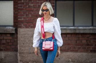 DUSSELDORF, GERMANY - JUNE 09: Lisa Hahnbueck is seen wearing Les Coyotes de Paris cropped white off shoulder top, flared Citizens of Humanity jeans, red Roger Vivier bag Gucci sunglasses on June 09, 2020 in Dusseldorf, Germany. (Photo by Christian Vierig/Getty Images)
