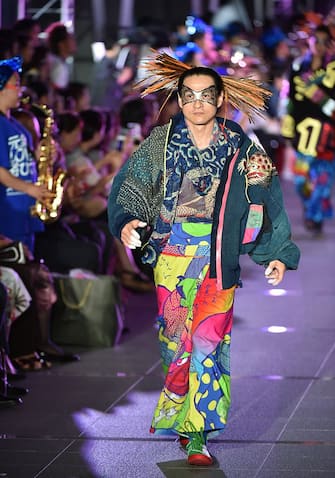 A model displays a creation during the fashion event "super energy !!" produced by Japanese designer Kansai Yamamoto in Tokyo on June 12, 2015. AFP PHOTO / KAZUHIRO NOGI        (Photo credit should read KAZUHIRO NOGI/AFP via Getty Images)