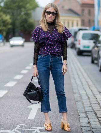 838635200 OSLO, NORWAY - AUGUST 24: Annabel Rosendahl wearing a black Loewe bag, purple blouse, denim jeans outside Vanessa Rudjord on August 24, 2017 in Oslo, Norway. (Photo by Christian Vierig/Getty Images)