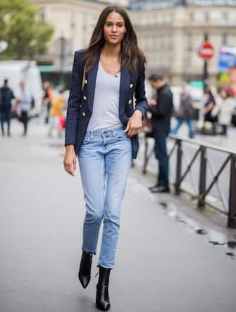 855244412 PARIS, FRANCE - SEPTEMBER 28: Model Cindy Bruna wearing denim jeans, ankle boots, blazer, white tshirt is seen outside Balmain during Paris Fashion Week Spring/Summer 2018 on September 28, 2017 in Paris, France. (Photo by Christian Vierig/Getty Images)