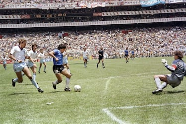 Argentinian forward Diego Armando Maradona (3rd L) runs past English defender Terry Butcher (L) on his way to dribbling goalkeeper Peter Shilton (R) and scoring his second goal, or goal of the century, during the World Cup quarterfinal soccer match between Argentina and England on June 22, 1986 in Mexico City. Argentina advanced to the semifinals with a 2-1 victory. (Photo by STAFF / AFP) (Photo by STAFF/AFP via Getty Images)