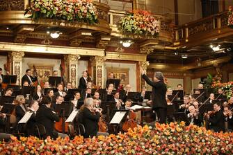 epa08914162 A handout photo made available by Vienna Philharmonic shows the orchestra led by Italian conductor Riccardo Muti (C-R) performing during the Wiener Philharmoniker (Vienna Philharmonic) New Year's Concert 2021 at the Musikverein concert hall in Vienna, Austria, 01 January 2021. The traditional concert, which is staged every year on 01 January, takes place without audience due to a nationwide lockdown caused by the ongoing Covid-19 coronavirus pandemic.  EPA/DIETER NAGL HANDOUT  HANDOUT EDITORIAL USE ONLY/NO SALES