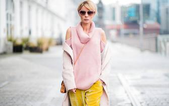 DUESSELDORF, GERMANY - DECEMBER 08: Gitta Banko wearing a pink cashmere turtleneck sweater with cut-outs on the shoulders by The Mercer NY, yellow velvet trousers by Mango, light-pink cashmere coat by Bruno Manetti, Stan Smith sneakers by Adidas, MCM cross-body bag, gold Y ring with watermelon tourmaline and diamonds and rose gold ladies watch by York Watches, sunglasses by Ray Ban on December 8, 2017 in Duesseldorf, Germany. (Photo by Christian Vierig/Getty Images)