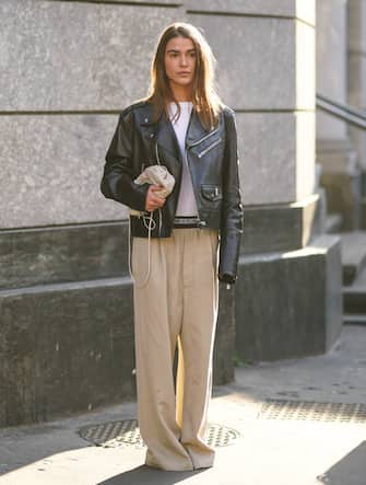 MILAN, ITALY - FEBRUARY 22: Sophia Roe wears a white top, a black leather biker jacket, beige wide-legs full-length pleated pants, a beige woven leather bag, outside Philosophy, during Milan Fashion Week Fall/Winter 2020-2021 on February 22, 2020 in Milan, Italy. (Photo by Edward Berthelot/Getty Images)