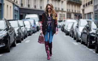 PARIS, FRANCE - SEPTEMBER 26: Alexandra Lapp wearing an oversized college jacket in leather from Set Fashion, a plaid shirt with studs from Set, high waist skinny jeans by Rag and Bone, Milla Tote bag with studded outlines in rustic brown from MCM, Les Specs sunglasses, and overknee boots in burgundy by Zara is seen during Paris Fashion Week Spring/Summer 2018 on September 26, 2017 in Paris, France. (Photo by Christian Vierig/Getty Images)