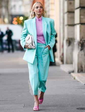 PARIS, FRANCE - JANUARY 20: Leonie Hanne wears earrings, a mauve hi-neck top, a sea-green jacket, matched crop cuffed pants, hot pink sandals, a cream-color quilted clutch, outside Ralph & Russo, during Paris Fashion Week - Haute Couture Spring/Summer 2020, on January 20, 2020 in Paris, France. (Photo by Edward Berthelot/Getty Images )