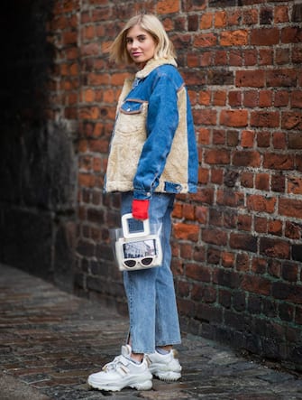 COPENHAGEN, DENMARK - JANUARY 30: Xenia Adonts is seen wearing shearling denim jacket, jeans with slit, see trough bag, sneaker outside Holzweiler during the Copenhagen Fashion Week Autumn/Winter 2019 - Day 2 on January 30, 2019 in Copenhagen, Denmark. (Photo by Christian Vierig/Getty Images)