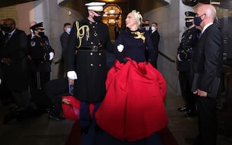 WASHINGTON, DC - JANUARY 20: Lady Gaga is escorted by U.S. Marine escort Capt. Evan Campbell to sing the National Anthem at the inauguration of U.S. President-elect Joe Biden on the West Front of the U.S. Capitol on January 20, 2021 in Washington, DC.  During todayâ  s inauguration ceremony Joe Biden becomes the 46th president of the United States. (Photo by Win McNamee/Getty Images)
