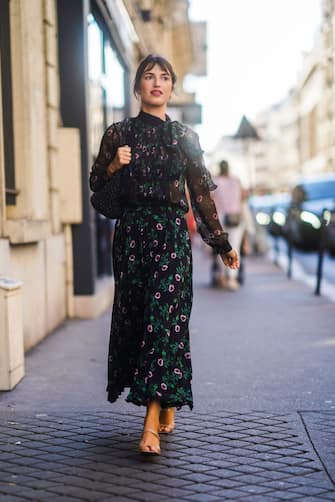 1160391063 PARIS, FRANCE - JULY 03: Jeanne Damas wears a floral print black mesh dress, a bag, outside Valentino, during Paris Fashion Week -Haute Couture Fall/Winter 2019/2020, on July 03, 2019 in Paris, France. (Photo by Edward Berthelot/Getty Images)