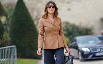 PARIS, FRANCE - FEBRUARY 27:  Jeanne Damas wears a brown jacket, sunglasses, flare pants, a bag, outside Dior, during Paris Fashion Week Womenswear Fall/Winter 2018/2019, on February 27, 2018 in Paris, France.  (Photo by Edward Berthelot/Getty Images)