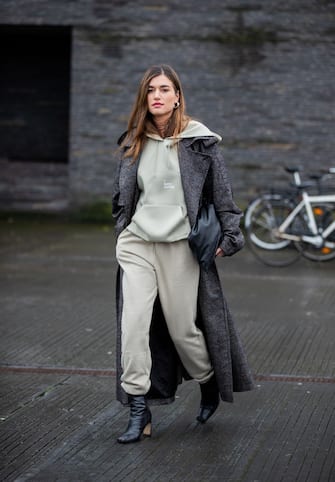 COPENHAGEN, DENMARK - JANUARY 28: A guest is seen wearing hoody, jogger pants, grey coat outside 7 Days on Day 1 during Copenhagen Fashion Week Autumn/Winter 2020 on January 28, 2020 in Copenhagen, Denmark. (Photo by Christian Vierig/Getty Images)