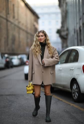 1207609927 MILAN, ITALY - FEBRUARY 20: Emili Sindlev wearing a Loewe bag and Ganni boots outside Max Mara during Milan Fashion Week Fall/Winter 2020-2021 on February 19, 2020 in Milan, Italy. (Photo by Jeremy Moeller/Getty Images)