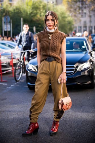 PARIS, FRANCE - SEPTEMBER 27:  Camila Coelho, wearing a sleeveless brown sweater, tan pants, red boots and Chloe bag, is seen after the Chloe show on September 27, 2018 in Paris, France. (Photo by Claudio Lavenia/Getty Images)