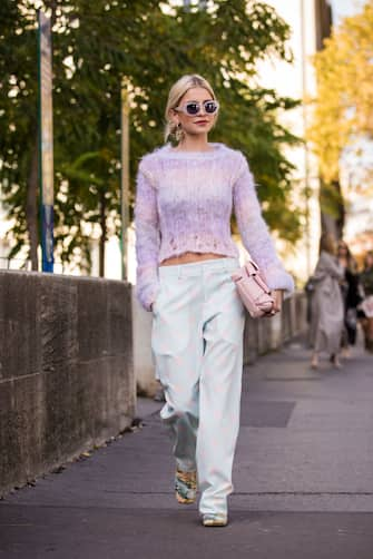 PARIS, FRANCE - SEPTEMBER 29:  Caroline Daur, wearing a pink sweater, light blue and light pink polka dot pants, pink bag and printed shoes, is seen before the Haider Ackermann show on September 29, 2018 in Paris, France. (Photo by Claudio Lavenia/Getty Images)