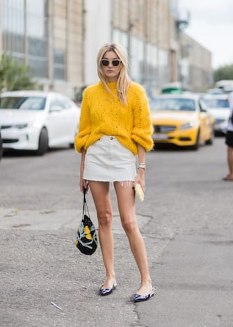 829545206 COPENHAGEN, DENMARK - AUGUST 10: Camille Charriere wearing a yellow knit, mini skirt outside Ganni on August 10, 2017 in Copenhagen, Denmark. (Photo by Christian Vierig/Getty Images)