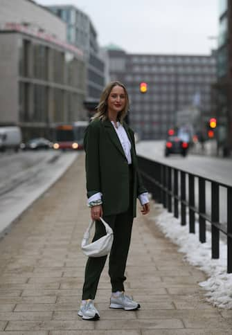 HAMBURG, GERMANY - FEBRUARY 02: Louisa Theresa Grass wearing green Nakd suit, white H&M blouse, New Balance sneaker and beige Bottega Veneta bag on February 02, 2021 in Hamburg, Germany. (Photo by Jeremy Moeller/Getty Images)