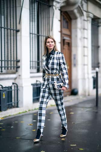 PARIS, FRANCE - DECEMBER 04: Natalia Verza aka "Mascarada Paris" wears a black shirt, a black and white checked blazer jacket from Baum Pfertgarten, suit pants, a golden chain belt from Chanel, a Chanel bag, black socks, pointy bronze colored pointy shiny shoes with golden logo from Salvatore Ferragamo, on December 04, 2020 in Paris, France. (Photo by Edward Berthelot/Getty Images)