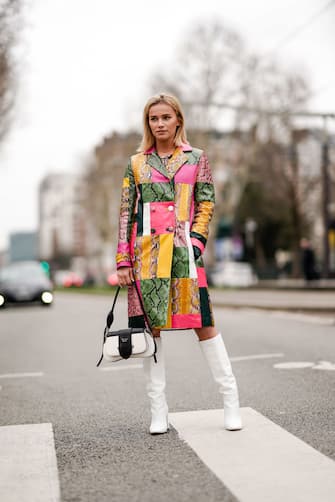 PARIS, FRANCE - MARCH 01: Julia Kuczynska "Maffashion" wears a multicolor snake print vinyl trench coat, white boots, a Prada bag, outside Nina Ricci, during Paris Fashion Week Womenswear Fall/Winter 2019/2020, on March 01, 2019 in Paris, France. (Photo by Edward Berthelot/Getty Images)