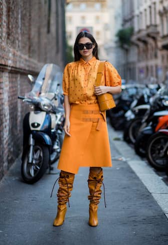 MILAN, ITALY - SEPTEMBER 21: Doina Ciobanu wearing yellow orange blouse and skirt, noots is seen outside Max Mara during Milan Fashion Week Spring/Summer 2018 on September 21, 2017 in Milan, Italy. (Photo by Christian Vierig/Getty Images)