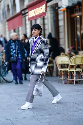 PARIS, FRANCE - JANUARY 22: Maria Bernad wears earrings, a black and white checked oversized jacket, a white shirt, a purple shirt, white shoes, a bag made of clear plastic parts, outside Viktor & Rolf, during Paris Fashion Week - Haute Couture Spring/Summer 2020, on January 22, 2020 in Paris, France. (Photo by Edward Berthelot/Getty Images )