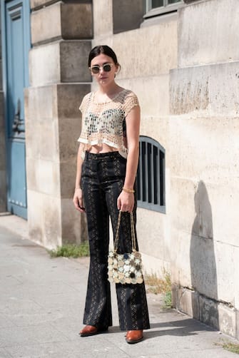 1168451104 PARIS, FRANCE - JULY 01: Art director Madelynn Furlong wears a Paco Rabanne bag, Dundas top, Gucci trousers and Chloe boots on July 01, 2019 in Paris, France. (Photo by Kirstin Sinclair/Getty Images)