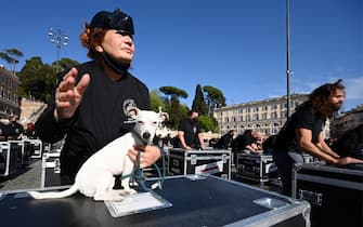 Entertainment workers bang on equipment cases during a flashmob performance called by the 'Bauli in Piazza' movement to protest against restrictions and closures linked to the coronavirus Covid-19 pandemic, in central Rome's square of Piazza del Popolo on April 17, 2021. (Photo by Vincenzo PINTO / AFP) (Photo by VINCENZO PINTO/AFP via Getty Images)