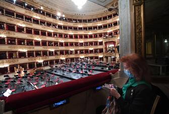 A woman, wearing face mask,waits the start of  the concert directed by the musical director Riccardo Chailly that commemorates the 75th anniversary of the reopening of the Piermarini Hall after the years of the dictatorship, the II World War and the bombing with the historic concert directed by Arturo Toscanini on 11 May 1946, Milan, Italy, 10 May 2021. Today's concert is the first event with the presence of audience since 19 October 2020. Only 500 tickets of the approximately 2000 seats were made available as required by current anti-covid legislation. ANSA/DANIEL DAL ZENNARO