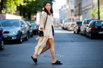 BERLIN, GERMANY - JUNE 06: Model Alyssa Cordes wearing Gestuz kimono, slip-on Suicoke shoes, black vintage leather shorts and white blouse, black APC bag on June 6, 2018 in Berlin, Germany. (Photo by Christian Vierig/Getty Images)