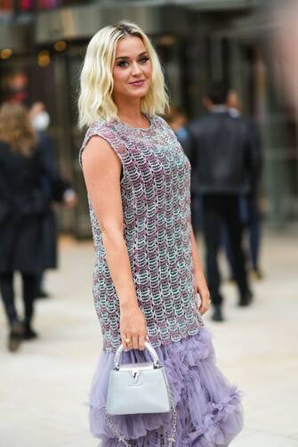 PARIS, FRANCE - JULY 05: Katy Perry wears a silver and pink sleeveless mesh tank top, a purple ruffled pleated skirt, a silver Vuitton bag, outside Louis Vuitton Parfum hosts dinner at Fondation Louis Vuitton, during Paris Fashion Week - Haute Couture Fall/Winter 2021/2022, on July 05, 2021 in Paris, France. (Photo by Edward Berthelot/Getty Images)