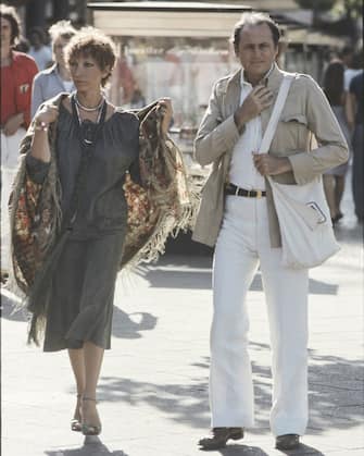 "The italian actress Mariangela Melato walks with her partner the italian musician and radio speaker Renzo Arbore. Berlin (Germany), 1977.  (Photo by Rino Petrosino\Mondadori via Getty Images)"