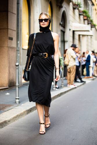 MILAN, ITALY - JUNE 16: Caro Daur, wearing a black dress and Celine sunglasses, is seen in the streets of Milan before the Versace show, during Milan Men's Fashion Week Spring/Summer 2019 on June 16, 2018 in Milan, Italy. (Photo by Claudio Lavenia/Getty Images)