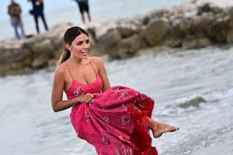 Italian actress Serena Rossi, who is to host the opening and closing nights of the 78th Venice International Film Festival, splashes water as she poses for photographers during a photo call on the beach of the Excelsior Hotel at Venice Lido on August 31, 2021, on the eve of the festival's opening. (Photo by MIGUEL MEDINA / AFP) (Photo by MIGUEL MEDINA/AFP via Getty Images)