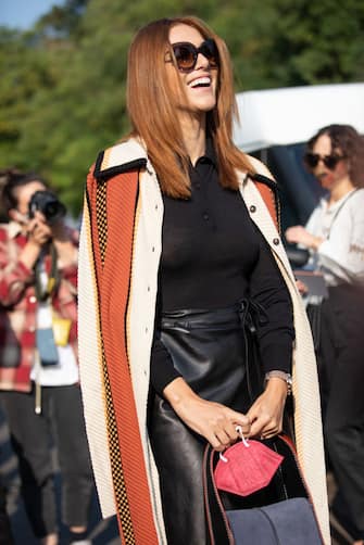 MILAN, ITALY - SEPTEMBER 24: Actress Miriam Leone outside Tod's fashion show wearing a Long striped coat, black leather skirt and black top and bag during the Milan Fashion Week - Spring / Summer 2022 on September 24, 2021 in Milan, Italy. (Photo by Valentina Frugiuele/Getty Images)