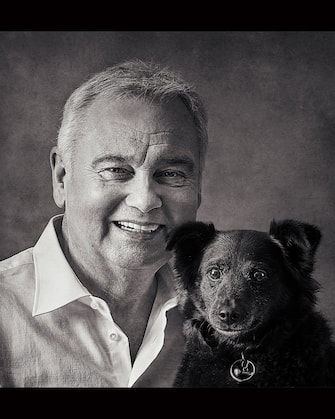 Eamonn Holmes, with rescue dog Maggie. See SWNS story SWBRdogs. Celebrity portrait photographer Andy Gotts has created a series of stunning images of the UK's most famous faces - and their dogs. The world-renowned photographer has teamed up with Guide Dogs and its A-list supporters to shine a light on the stars’ most loyal fans. Simon Cowell, David Walliams, Tilda Swinton and Fiona Bruce were among the celebs who posed with their pooches to celebrate the charity’s 90th anniversary and help launch the 2021 Guide Dogs Appeal to fund life-changing services for people with sight loss. David Walliams, who was photographed with border terriers Bert and Ernie, said: “Guide Dogs is such an amazing charity and is one of the first charities you hear about as a child. 