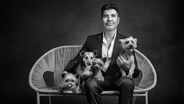 Simon Cowell with Squiddly, Diddly, Freddy and Daisy. See SWNS story SWBRdogs. Celebrity portrait photographer Andy Gotts has created a series of stunning images of the UK's most famous faces - and their dogs. The world-renowned photographer has teamed up with Guide Dogs and its A-list supporters to shine a light on the stars’ most loyal fans. Simon Cowell, David Walliams, Tilda Swinton and Fiona Bruce were among the celebs who posed with their pooches to celebrate the charity’s 90th anniversary and help launch the 2021 Guide Dogs Appeal to fund life-changing services for people with sight loss. David Walliams, who was photographed with border terriers Bert and Ernie, said: “Guide Dogs is such an amazing charity and is one of the first charities you hear about as a child. 