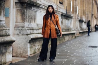 PARIS, FRANCE - MARCH 04: Model Hoyeon Jung wears a brown leather blazer, Louis Vuitton bag, black pants, and black boots after the Beautiful People show during Paris Fashion Week Fall/Winter 2019 on March 04, 2019 in Paris, France. (Photo by Melodie Jeng/Getty Images)