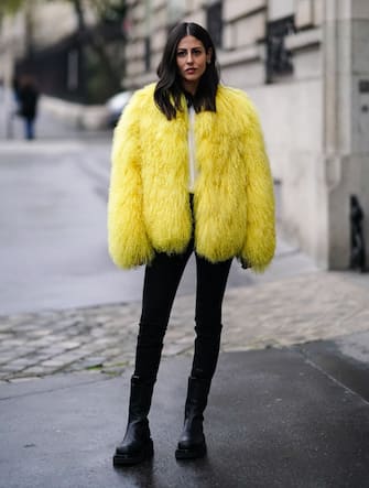 PARIS, FRANCE - FEBRUARY 28: Gilda Ambrosio wears a yellow fluffy faux fur coat, black pants, black leather boots, outside Alessandra Rich, during Paris Fashion Week - Womenswear Fall/Winter 2020/2021, on February 28, 2020 in Paris, France. (Photo by Edward Berthelot/Getty Images)