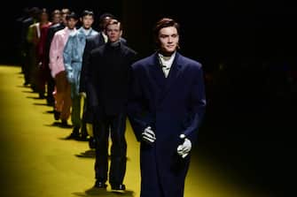 British actor Louis Partridge (Front R), followed by British actor Thomas Brodie-Sangster and models present creations for Prada's Men's Fall / Winter 2022/2023 fashion collection on January 16, 2022 in Milan.  (Photo by MIGUEL MEDINA / AFP) (Photo by MIGUEL MEDINA / AFP via Getty Images)