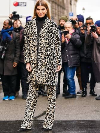 PARIS, FRANCE - MARCH 02: Bianca Brandolini wears earrings, a black turtleneck, a light yellow and black leopard print coat, matched full-length pants, black pointy shoes, outside Giambattista Valli, during Paris Fashion Week - Womenswear Fall/Winter 2020/2021, on March 02, 2020 in Paris, France. (Photo by Edward Berthelot/Getty Images)