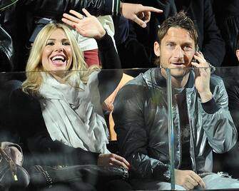 AS Roma's captain Francesco Totti (R) and his wife Ilary Blasi watch the match between Spanish Rafael Nadal and Romanian Victor Hanescu during their ATP Tennis Open match in Rome on April 29, 2010 in Rome.  Nadal won 6-3 6-2.   AFP PHOTO/ ANDREAS SOLARO        (Photo credit should read ANDREAS SOLARO/AFP via Getty Images)