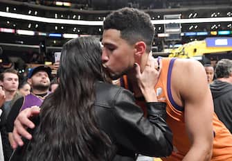 LOS ANGELES, CA - OCTOBER 22: Kendall Jenner and Devin Booker #1 of the Phoenix Suns kiss and hug after the Suns defeated the Los Angeles Lakers, 115-110, at Staples Center on October 22, 2021 in Los Angeles, California. NOTE TO USER: User expressly acknowledges and agrees that, by downloading and/or using this Photograph, user is consenting to the terms and conditions of the Getty Images License Agreement. (Photo by Kevork Djansezian/Getty Images)