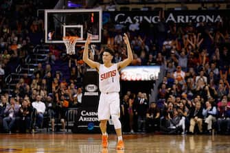 PHOENIX, AZ - JANUARY 06:  Devin Booker #1 of the Phoenix Suns reacts after the Suns scored against the Charlotte Hornets during the second half of the NBA game at Talking Stick Resort Arena on January 6, 2016 in Phoenix, Arizona.  The Suns defeated the Hornets 111-102. NOTE TO USER: User expressly acknowledges and agrees that, by downloading and or using this photograph, User is consenting to the terms and conditions of the Getty Images License Agreement.  (Photo by Christian Petersen/Getty Images)