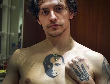 TOPSHOT - Ukrainian-born ballet dancer and actor Sergei Polunin, 29-years-old, shows his tattoos, the one depicting Russian President Vladimir Putin and the other featuring the Ukrainian national trident symbol, during an interview with AFP in Moscow on February 14, 2019. - In his Moscow dressing room, dancer Sergei Polunin pulls off his T-shirt to show the tattoo of President Vladimir Putin on his chest as the Ukrainian-born ballet star premieres his new show in the Russian capital. "I see a good energy in him," he says of the Russian leader. Polunin has been acclaimed by critics a ballet great on the level of Mikhail Baryshnikov or Vaslav Nijinsky, has long been dogged by the label of "the bad boy of ballet". (Photo by Alexander NEMENOV / AFP) (Photo by ALEXANDER NEMENOV/AFP via Getty Images)