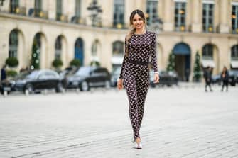 PARIS, FRANCE - NOVEMBER 19: Patricia Gloria Contreras wears gold earrings, a large gold chain necklace, a gold pendant necklace, a brown with beige moon print pattern belted jumpsuit from Marine Serre, a pink gold watch, silver rhinestones asymmetric pumps heels shoes, during a street style fashion photo session, on November 19, 2021 in Paris, France. (Photo by Edward Berthelot/Getty Images)