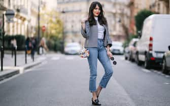 PARIS, FRANCE - MARCH 11:  Sarah Benziane, fashion blogger, wears a Zara tweed checked jacket, a Zara white t-shirt, an Atelier Caesars multicolor bag, Newlook cropped blue denim jeans, and Newlook black shoes, on March 11, 2017 in Paris, France.  (Photo by Edward Berthelot/Getty Images)