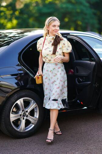 PARIS, FRANCE - JUNE 29: Sydney Sweeney wears a headband, a floral print yellow ruffled t-shirt, a pale blue floral print skirt, a yellow bag, shoes, outside Miu Miu Club 2020,  on June 29, 2019 in Paris, France. (Photo by Edward Berthelot/Getty Images)