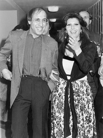 Italian singer-songwriter and actor Adriano Celentano walking arm in arm with his wife, Italian actress, singer and record producer Claudia Mori (Claudia Moroni) called as a guest at the 32nd Sanremo Music Festival. Sanremo, 1982 (Photo by Egizio Fabbrici/Mondadori via Getty Images)