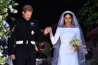 WINDSOR, UNITED KINGDOM - MAY 19: Britain's Prince Harry, Duke of Sussex and his wife Meghan, Duchess of Sussex leave from the West Door of St George's Chapel, Windsor Castle, in Windsor on May 19, 2018 in Windsor, England. (Photo by  Ben STANSALL - WPA Pool/Getty Images)